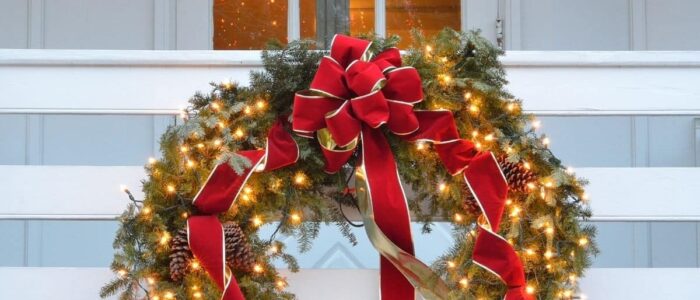 Christmas wreath on a white porch railing